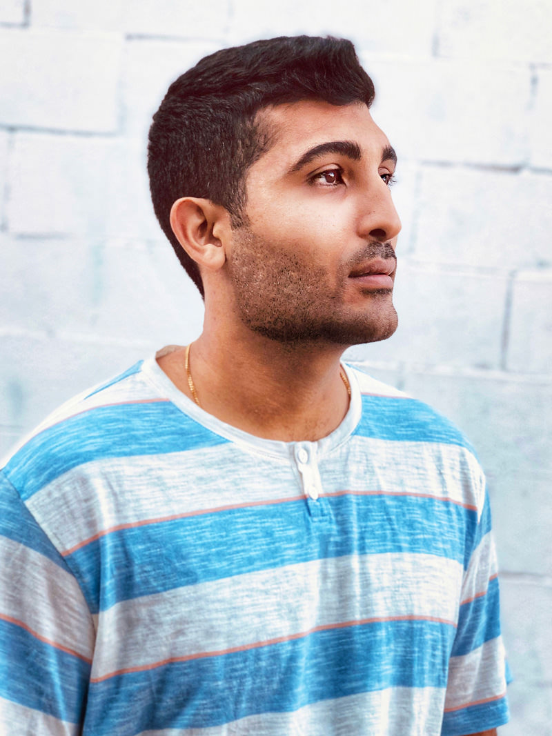 Arish Dubash wearing a blue-striped shirt