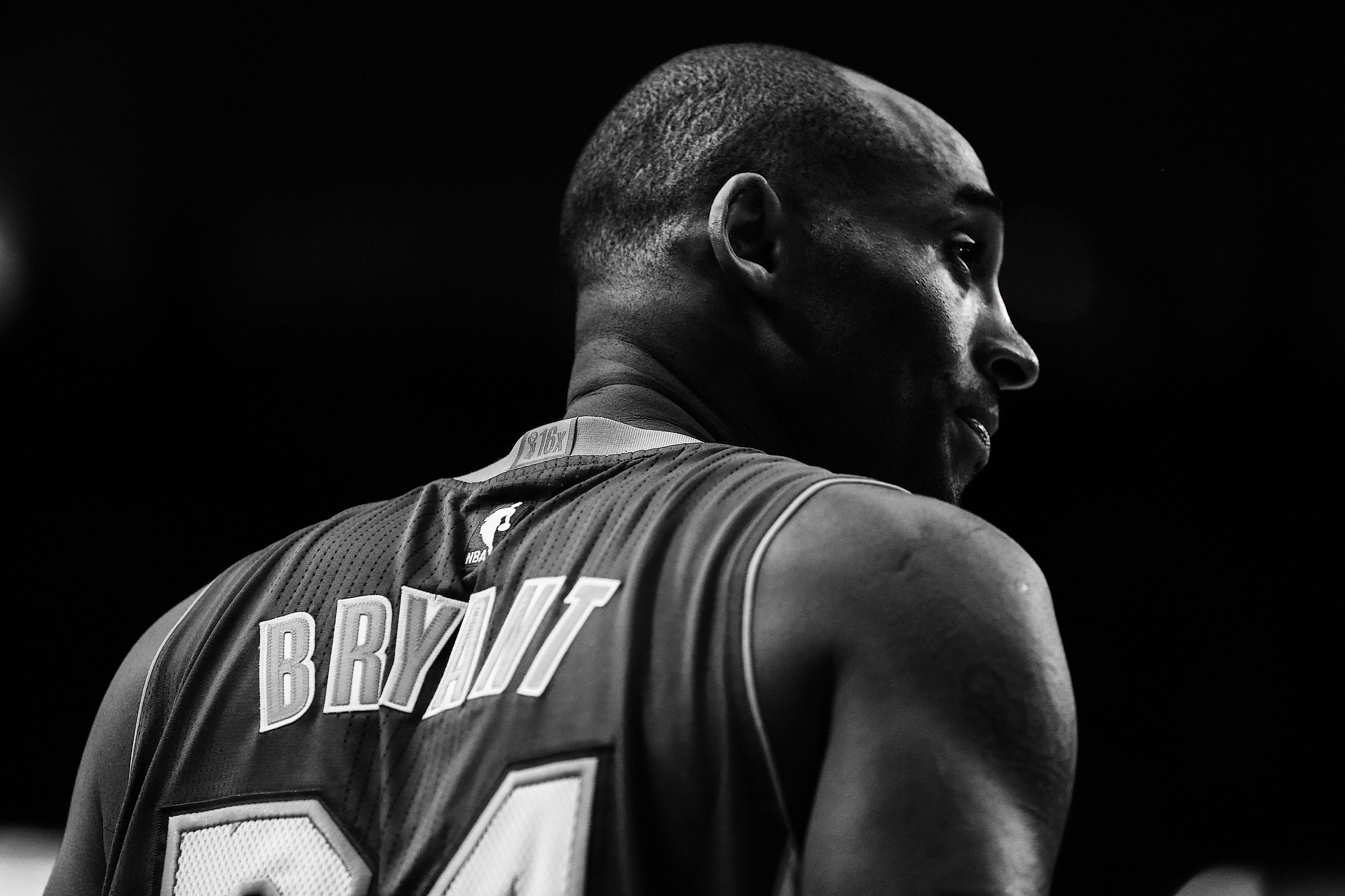 kobe bryant in a black and white photo glaring off into the distance